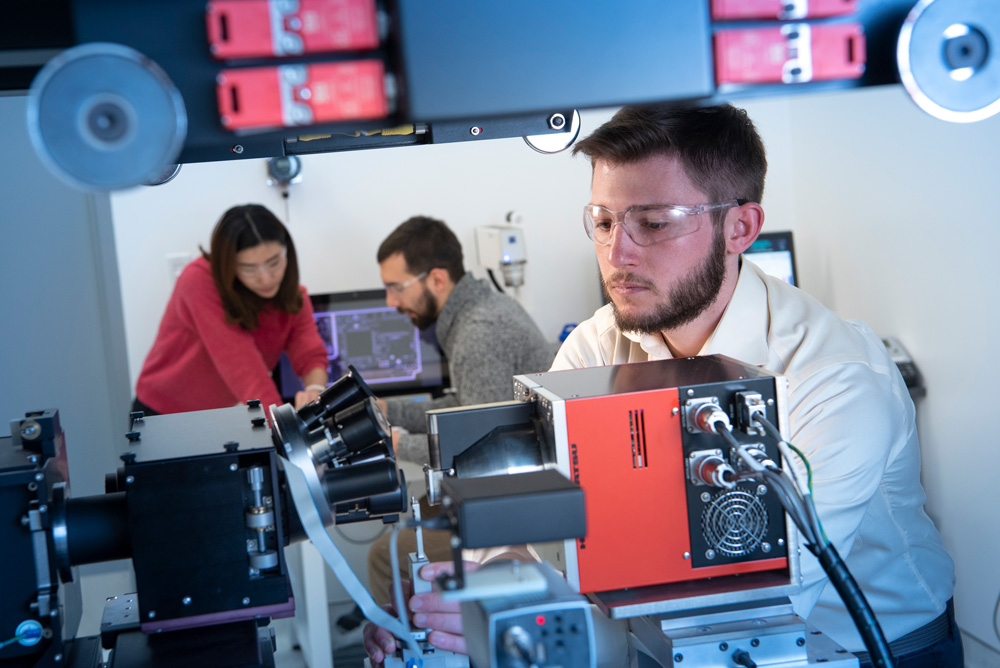 Feifei Yang, Diego Cerrai, in the background while Joe Favata using an instrument at the IPB