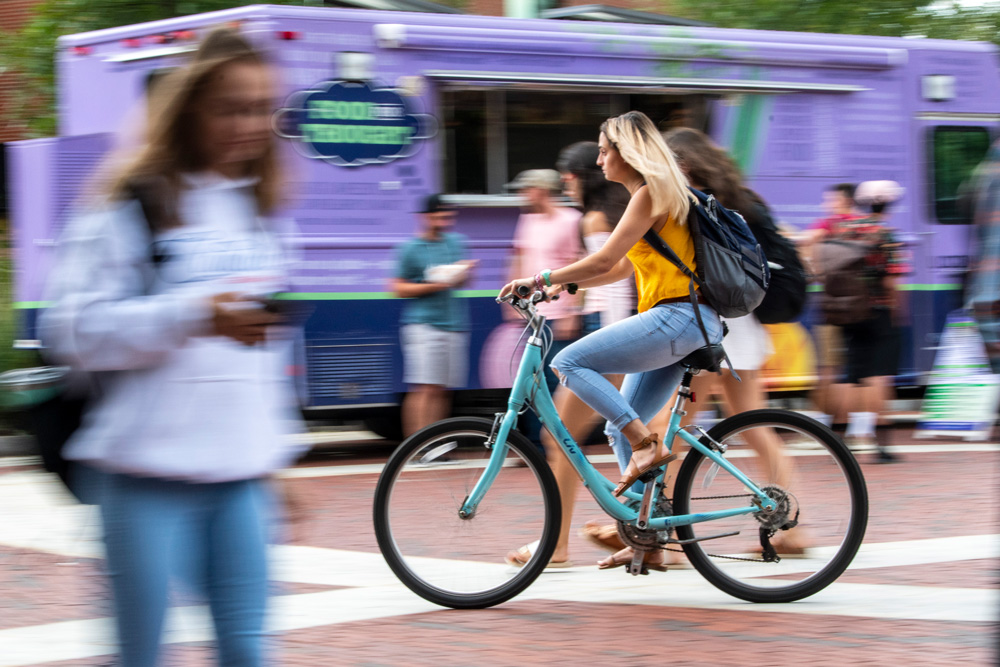 Students riding their bikes along Fairfield Way