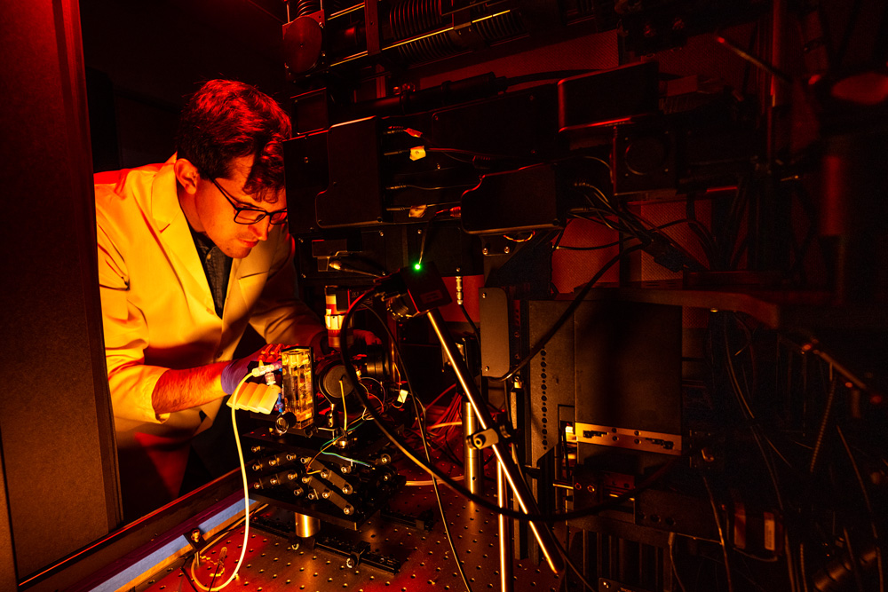 Male in a lab with orange light